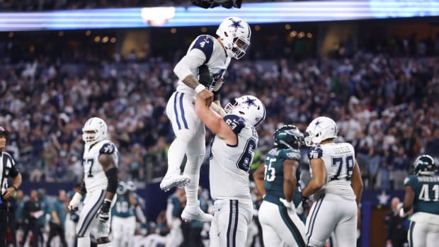 Dallas Cowboys quarterback Dak Prescott (4) celebrates a touchdown with Dallas Cowboys center Tyler Biadasz (63) in the second quarter at AT&T Stadium.